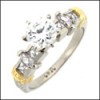 Two tone gold ring with round center stone/marquise and princess cut cz